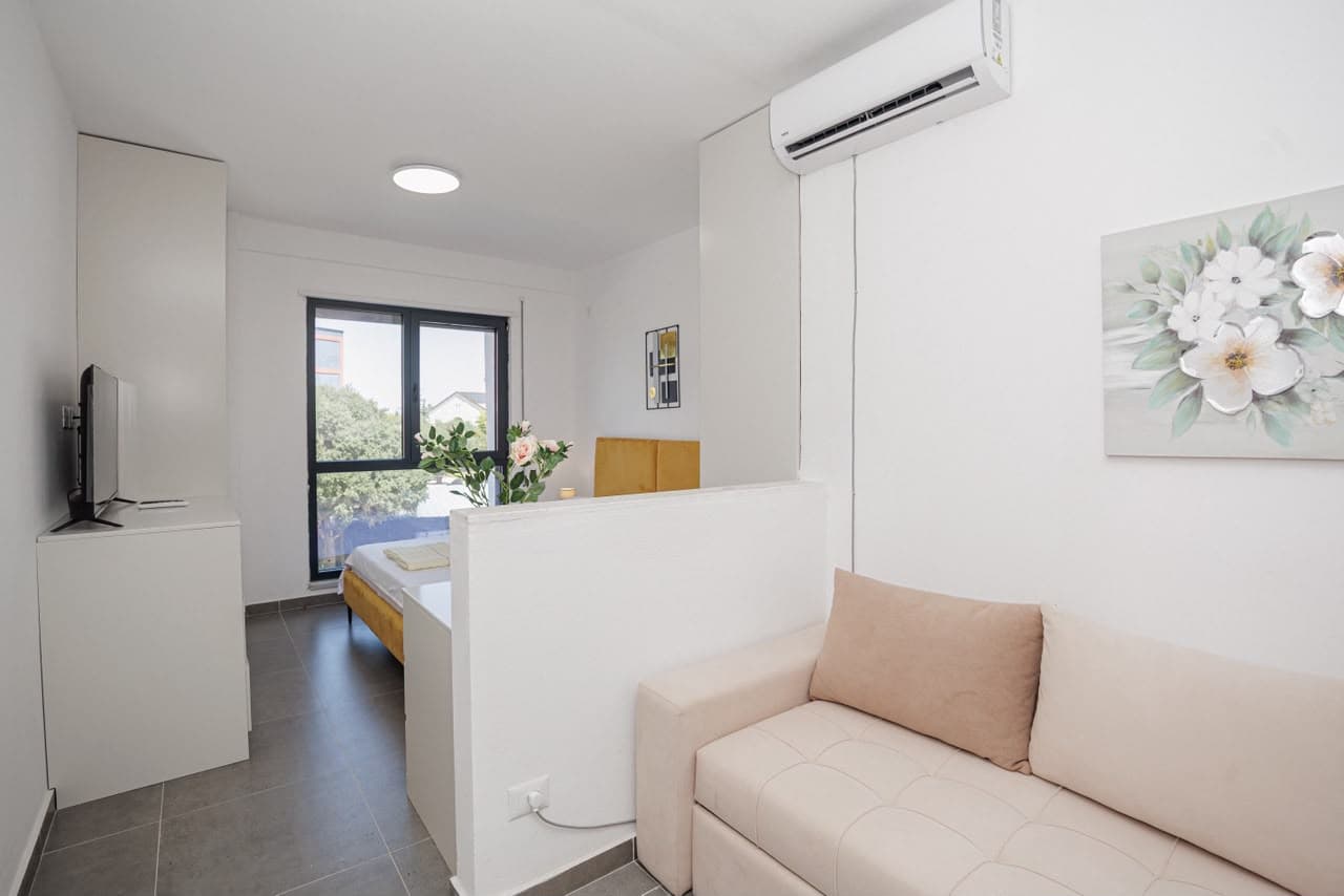 Bright living area with TV and sofa