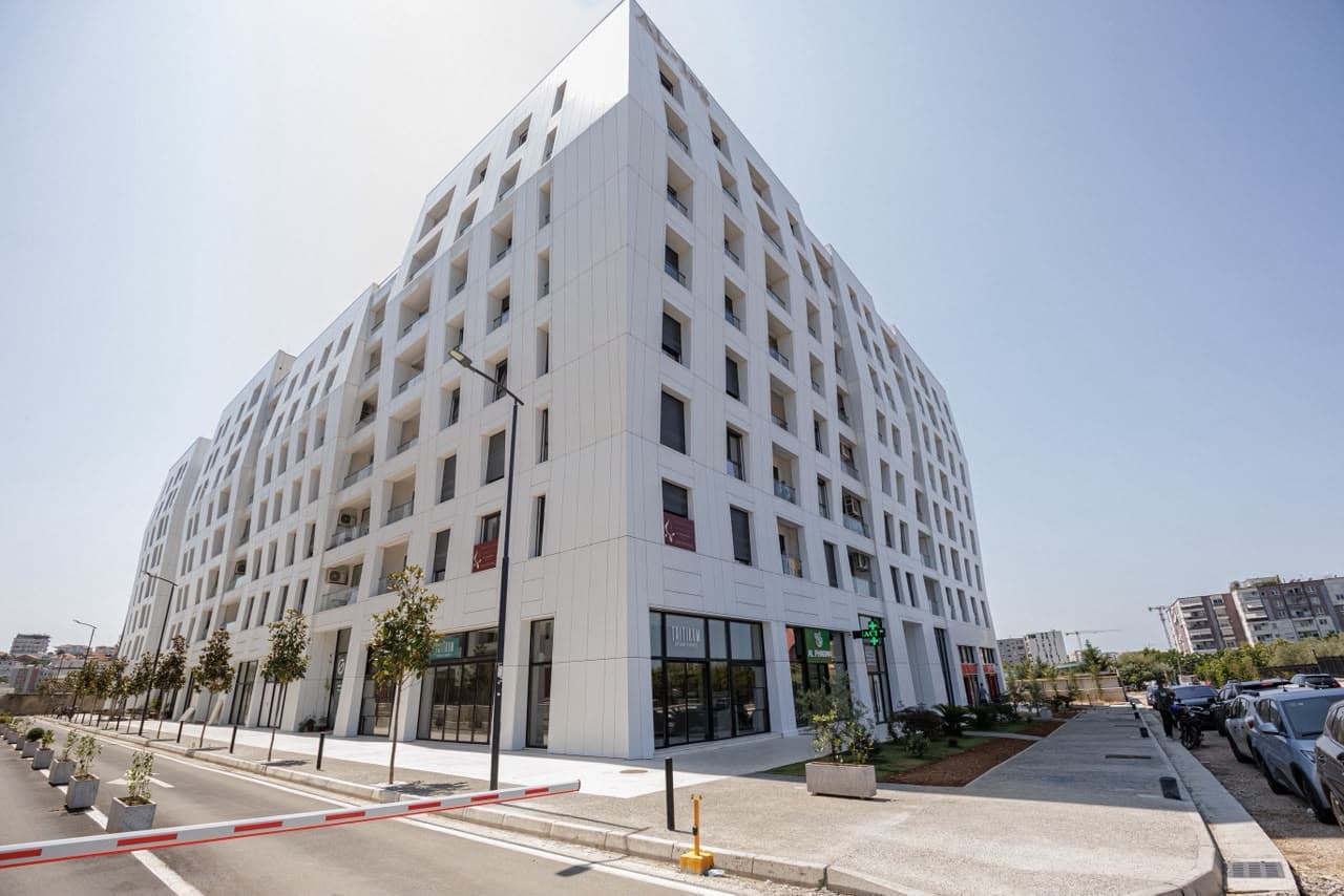 The modern residential building where the apartment is located